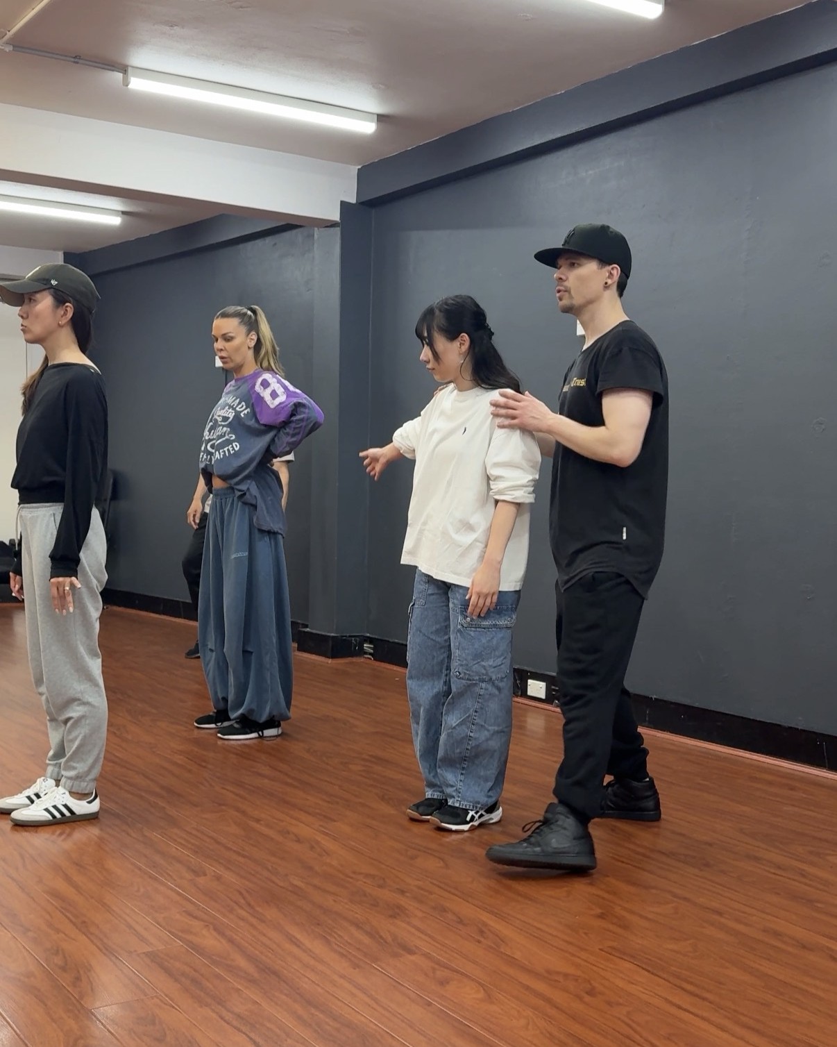James giving a dancer individual feedback while the group looks on
